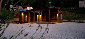 a small cabin on the beach at night at Tiny Merak - Ramsko jezero in Kovačevo Polje +5 photos