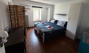 a bedroom with a bed and a table in it at La Locanda del Viandante in Mendrisio