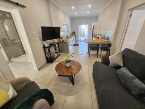 a living room with a couch and a table at Rosa's Self-catering in Springbok