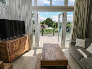 a living room with a television and a coffee table at Dales Retreat in Skipton