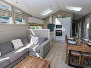 a living room with a couch and a table at Dales Retreat in Skipton