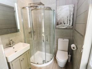 a bathroom with a shower and a toilet and a sink at Dales Retreat in Skipton +22 photos
