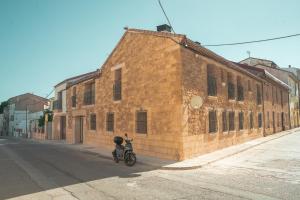 a motorcycle parked in front of a brick building at Casa 'El Tio Pedro' in Alcañiz