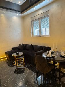 a living room with a couch and two tables at A&S apartmani 2 in Smederevo