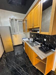 a kitchen with a sink and a refrigerator at A&S apartmani 2 in Smederevo
