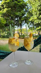 two drinks in glasses sitting on a table at Studio Iloa Vista Piscina 004V in Barra de São Miguel