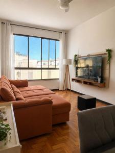 a living room with a couch and a flat screen tv at Copacabana Rooms & Hostel in Rio de Janeiro