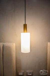 a light fixture hanging from a wall in a room at Rubin Boutique in Korçë +18 photos