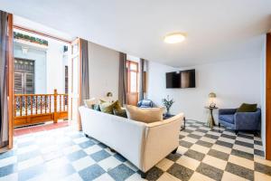 a living room with a couch and a television at Casa Las Ruinas Boutique Hotel in San Juan +17 photos