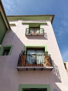 a tall building with two balconies and a window at Casa Rosetta Boutique in Xàtiva