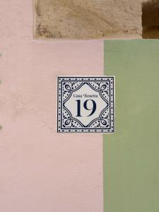 a sign on a wall with the number at Casa Rosetta Boutique in Xàtiva +37 photos