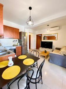 a kitchen and living room with a table and chairs at Side Sea View Apartment in Neoi Epivates