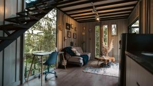 a living room with a table and a couch at ZIRUMA HOUSE in Santa Elena