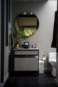 a bathroom with a sink and a mirror at ZIRUMA HOUSE in Santa Elena +34 photos