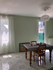 a dining room with a table and two chairs at La Catalane in Perpignan +19 photos