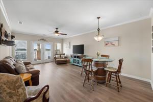 a living room with a table and chairs at Lakefront Paradise with Stunning Views! in Corsicana