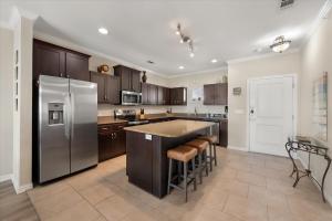 a kitchen with stainless steel appliances and a large island at Lakefront Paradise with Stunning Views! in Corsicana