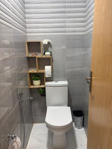 a bathroom with a toilet and a shower at perle rare plage des Nations in Sidi Bouqnadel +14 photos