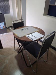 a wooden table with a laptop on top of it at Elimisam cabin in Kitwe
