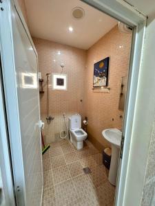 a bathroom with a toilet and a sink at luule in Al Ain +57 photos