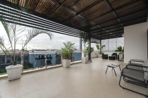 a large room with large windows and plants at Yaniv Apartments Oniru in Lagos