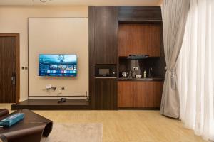 a living room with a tv on a wall at Yaniv Apartments Oniru in Lagos