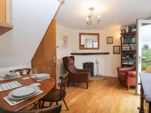 a dining room with a table and chairs at The Spinney in Milnthorpe