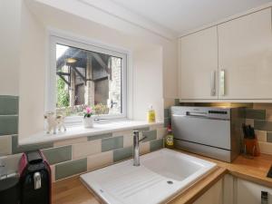 a kitchen with a sink and a window at The Spinney in Milnthorpe +20 photos