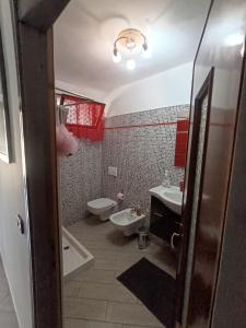 a bathroom with a sink and a toilet and a tub at La casa dei Ruc in Capo di Ponte +20 photos