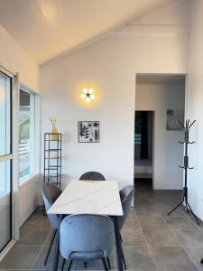 a dining room with a white table and chairs at Villa Alizé Kreyol in Le François +29 photos