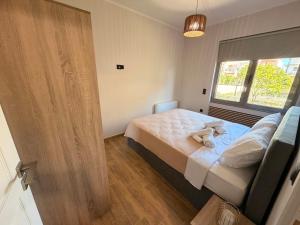 a bedroom with a bed with a stuffed animal on it at Casa Marino in Chalkida