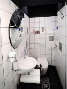 a white bathroom with a sink and a toilet at Alt Wien in Vienna
