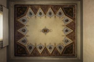 a ceiling with a circular design on a wall at Porta Rossa Hotel Firenze, Colbert Collection in Florence