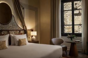 a hotel room with a bed and a window at Porta Rossa Hotel Firenze, Colbert Collection in Florence