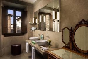 a bathroom with two sinks and a large mirror at Porta Rossa Hotel Firenze, Colbert Collection in Florence +100 photos