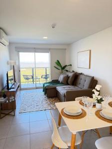 a living room with a couch and a table at Apartamento completamente equipado! Con Parking! En Paraná Playa Deptos! in Encarnación