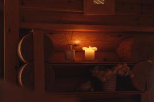 a candle sitting on a shelf in a room at Northern Nest by Elys Collection in Kittilä