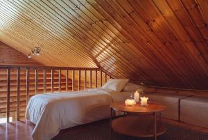 a bedroom with a bed and a table with candles at Northern Nest by Elys Collection in Kittilä +12 photos