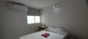 a bedroom with a bed with a pink bow on it at Apartment Neiva Rasan in Neiva