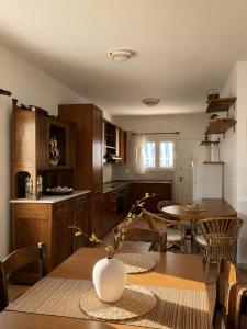 a kitchen and dining room with a table and chairs at Seascape Nafplio Residence in Vivari