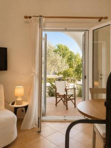 a room with a sliding glass door leading to a patio at Seascape Nafplio Residence in Vivari +14 photos