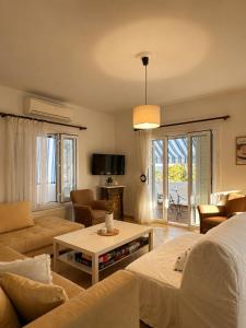 a living room with a couch and a table at Seascape Nafplio Residence in Vivari