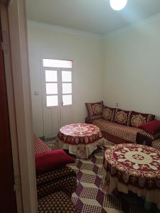 a living room with two tables and a couch at Dar Cadi in Safi