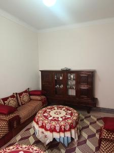 a living room with a couch and a table at Dar Cadi in Safi +3 photos