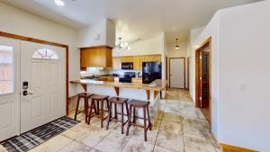 a kitchen with a island with bar stools at Canyon Portal #469 in Moab