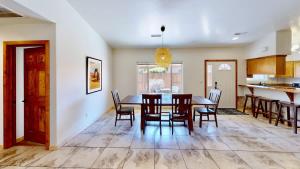 a dining room and kitchen with a table and chairs at Canyon Portal #469 in Moab