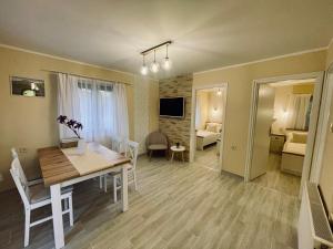 a living room with a table and a dining room at Bungalow Park Balatonboglár in Balatonboglár