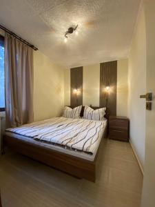a bedroom with a large bed in a room at Bungalow Park Balatonboglár in Balatonboglár +17 photos