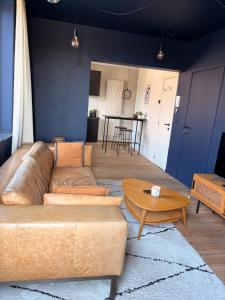 a living room with a couch and a table at Au pied du mur in Huy