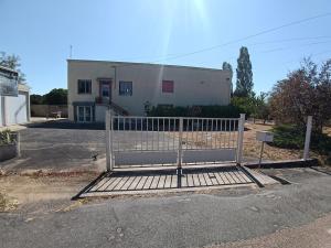 a gate in front of a white building at le bégare 